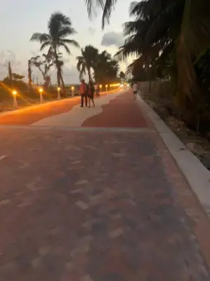 a group of people walking down a street at Ocean front 2 Bedroom and 2 Bathroom apartment at The Alexander Resort in Miami Beach