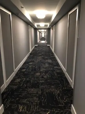 a long hallway with a carpeted floor in a building at Beach Front Resort - 2 Bedroom, 2 bathrooms, Sleeps 6, 2 Pools- at The Alexander in Miami Beach