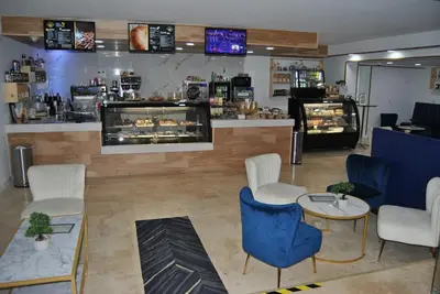 a restaurant with a counter with chairs and a table at Beach Front Resort - 2 Bedroom, 2 bathrooms, Sleeps 6, 2 Pools- at The Alexander in Miami Beach