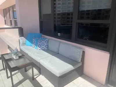 a couch sitting on a balcony with a table at Beach Front Resort - 2 Bedroom, 2 bathrooms, Sleeps 6, 2 Pools- at The Alexander in Miami Beach