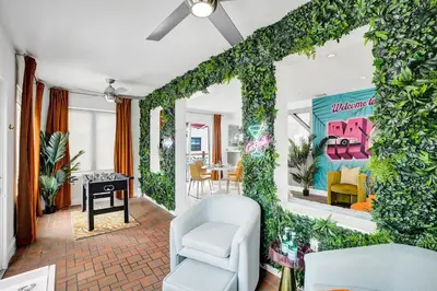 a living room with a wall covered in ivy at 5 Mins Brickell - Pool & Billiards - Retro Miami in Miami