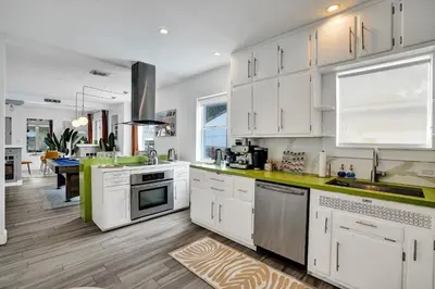 a kitchen with white cabinets and a counter top at 5 Mins Brickell - Pool & Billiards - Retro Miami in Miami