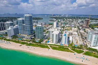 an aerial view of a city with a beach and buildings at New Mid Miami Beach apt free parking and beach access in Miami Beach