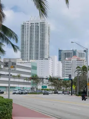 a city with a street with cars and tall buildings at New Mid Miami Beach apt free parking and beach access in Miami Beach