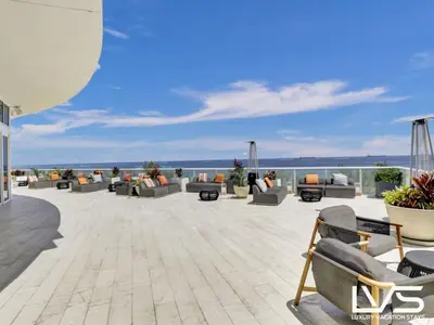 a patio with couches and the ocean in the background at W FTL 1409 Beachfront Resort 2 Bedroom & 2 Bathroom Condo in Fort Lauderdale