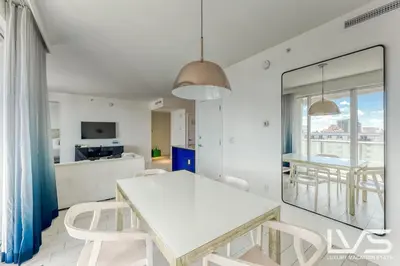 a dining room with a white table and chairs at W FTL 1409 Beachfront Resort 2 Bedroom & 2 Bathroom Condo in Fort Lauderdale