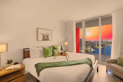 a bedroom with a large bed and a window at Spectacular Apt Infinity View Amazing Amenities in Hallandale Beach