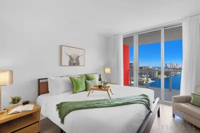a bedroom with a large bed and a large window at Spectacular Apt Infinity View Amazing Amenities in Hallandale Beach