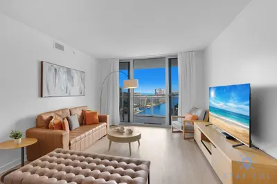 a living room with a couch and a tv at Spectacular Apt Infinity View Amazing Amenities in Hallandale Beach