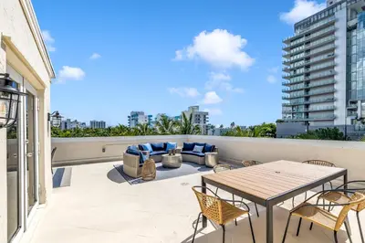 a patio with a table and chairs on a balcony at Gorgeous coastal PH with Large Private Terrace in Miami Beach