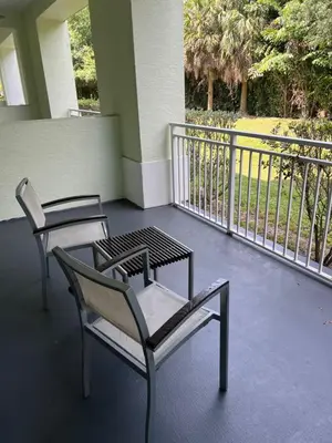 two chairs and a table on a balcony at Doral Pool 404 by Wave Properties in Miami