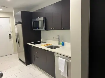 a kitchen with a sink and a microwave at Doral Pool 404 by Wave Properties in Miami