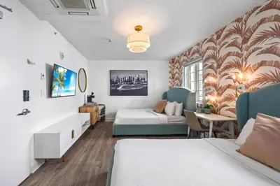 a hotel room with a bed and a couch at Luxuri Suites in Miami Beach