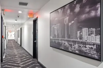 a hallway with a large picture on the wall at Luxuri Suites in Miami Beach