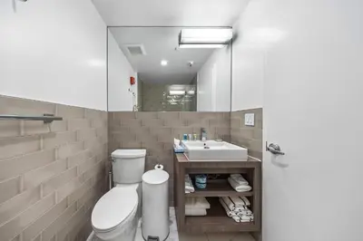 a bathroom with a toilet and a sink at Luxuri Suites in Miami Beach