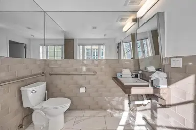 a bathroom with a toilet and a sink at Luxuri Suites in Miami Beach