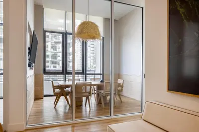 a dining room with a table and a large glass wall at Flow Hotel Miami in Miami