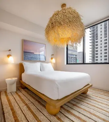 a bedroom with a large bed and a large window at Flow Hotel Miami in Miami