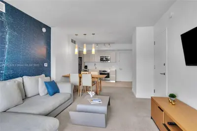 a living room with a couch and a table at Beautiful 2BR Balcony Pool Near Beach & Fun in Hallandale Beach
