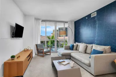 a living room with a couch and a tv at Spectacular 1BR Resort Pool Gym Near Beach in Hallandale Beach