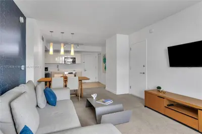 a living room with a couch and a tv at Spectacular 1BR Resort Pool Gym Near Beach in Hallandale Beach