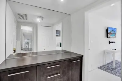 a bathroom with a large mirror and a sink at High floor 2BD with beach service 1616 in Miami Beach