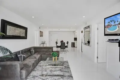 a living room with a couch and a tv at High floor 2BD with beach service 1616 in Miami Beach