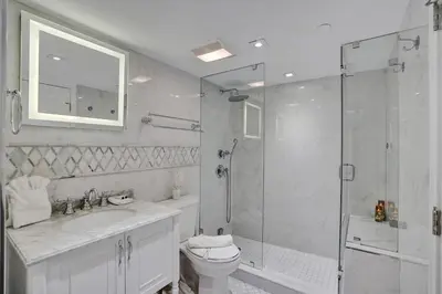 a bathroom with a shower and a toilet and a sink at Adorable 2 Bedroom Condo Beach Service 904 in Miami Beach