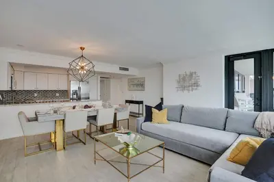 a living room with a couch and a table at Adorable 2 Bedroom Condo Beach Service 904 in Miami Beach