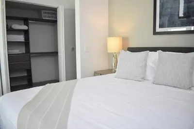 a bedroom with a white bed and a lamp at The Bayfront V in Miami