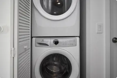 a washer and dryer in a corner of a room at The Bayfront V in Miami