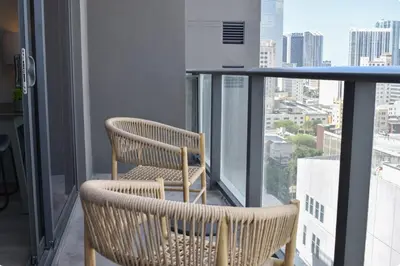 two chairs on a balcony with a view of a city at The Bayfront V in Miami