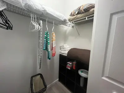 a room with a closet with several pairs of shoes at Chic Private Retreat in Homestead