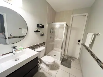 a bathroom with a toilet and a shower and a sink at Chic Private Retreat in Homestead