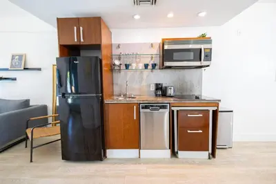 a kitchen with a black refrigerator and a microwave at King 1 Bed Apt with rooftop pool C202 in Miami Beach