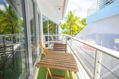 a wooden bench sitting on the balcony of a building at King 1 Bed Apt with rooftop pool C202 in Miami Beach