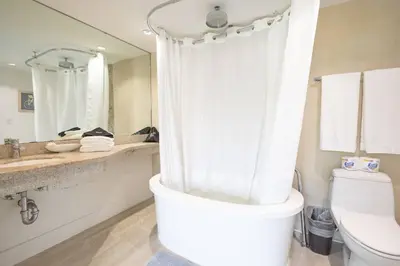 a bathroom with a shower and a toilet and a sink at King Bed-Apt with Rooftop Pool-Bar D303 in Miami Beach