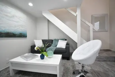 a living room with a couch and a chair at Modern Loft wsteps to Beach Kitchenette in Hollywood