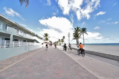 a group of people riding bikes on the beach at Modern Loft wsteps to Beach Kitchenette in Hollywood