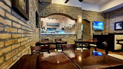 a restaurant with tables and chairs and a brick wall at The Link Hotel South Beach in Miami Beach