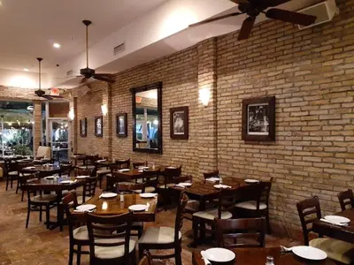 a restaurant with tables and chairs and a brick wall at The Link Hotel South Beach in Miami Beach