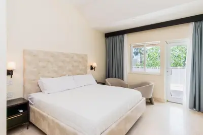 a bedroom with a large white bed and a window at The Link Hotel South Beach in Miami Beach