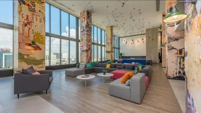 a living room with couches and tables and large windows at Apartment in Miami downtown in Miami