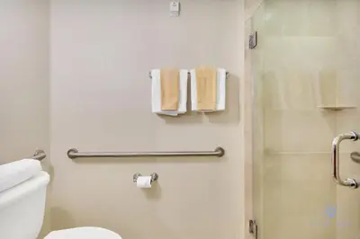 a bathroom with a shower and a toilet and towels at Deluxe Studio Balcony Bay View Amazing Pool in Sunny Isles Beach