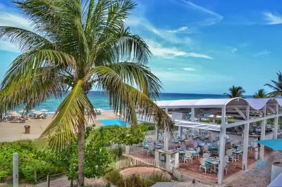 an aerial view of a resort with a palm tree at Deluxe Studio Balcony Bay View Amazing Pool in Sunny Isles Beach