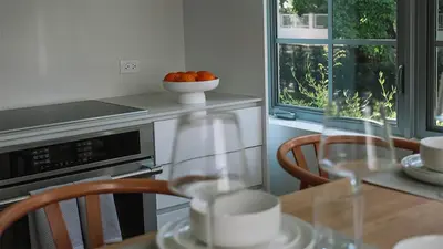 a kitchen with a table with a bowl of oranges at Beach Haus Design District in Miami