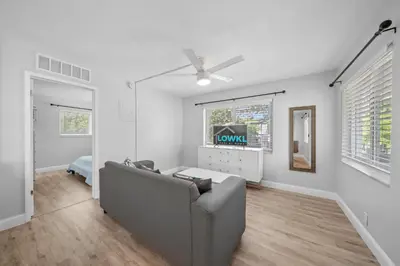 a living room with a couch and a window at Riverbend Apartments by Lowkl in Fort Lauderdale