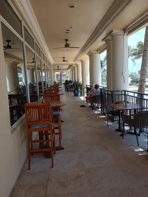 a row of tables and chairs in a restaurant at Private Residences at The Atlantic Resort & Spa in Fort Lauderdale