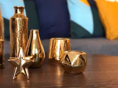 a table with gold shiny objects on it at GroveO5 10 minutes from Miami Beach in Miami