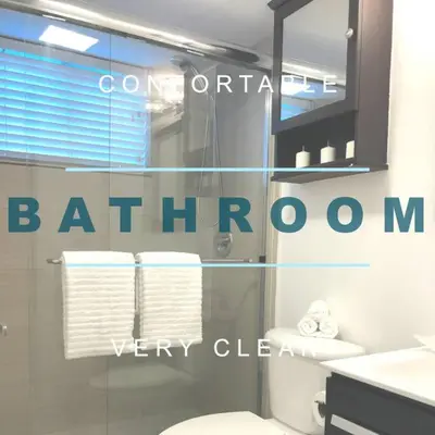 a bathroom with a toilet and a glass window at GroveO5 10 minutes from Miami Beach in Miami